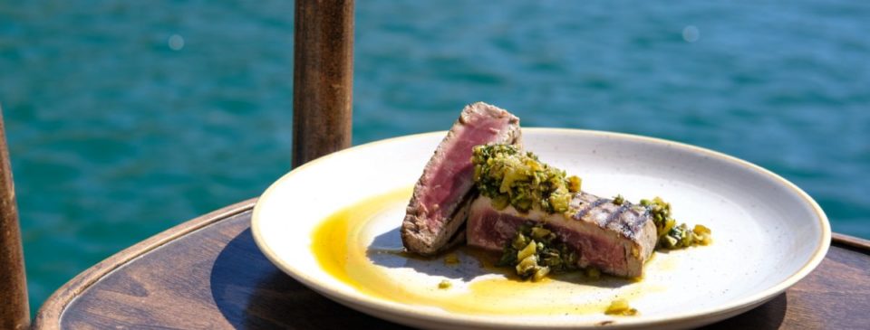 Succulent plate of grilled fish at Gululu, a local restaurant in Malta, showcasing a perfectly cooked, flavorful piece of fish with a smoky char, delivering a delightful seafood experience for diners.